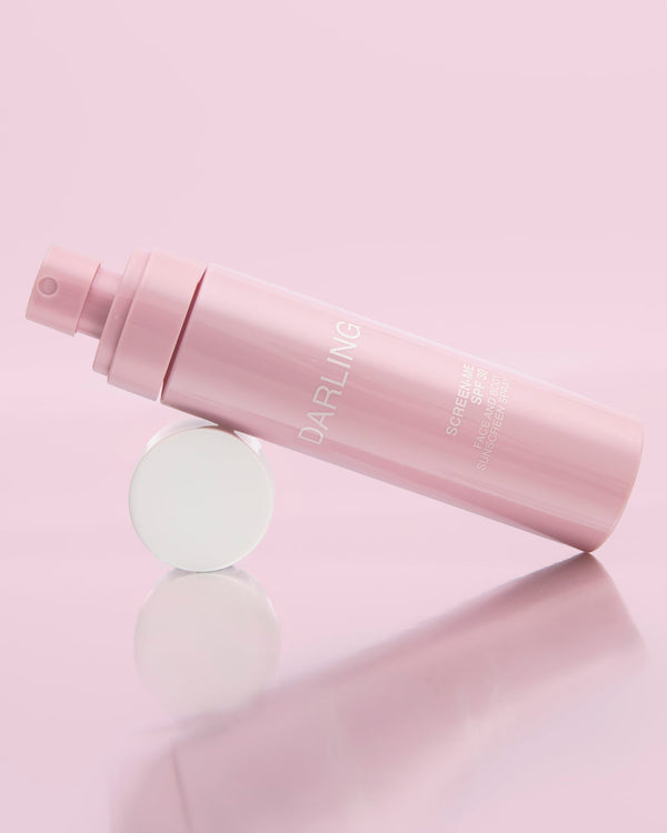 Darling Screen-Me Spray SPF 30 liggend op de dop, met verfijnde verpakking.