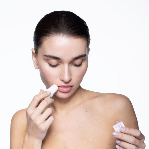 Mesoprotech-Sun-Stick-SPF-50-meteen-hand-die-de-stick-aanbrengt-op-de-lippen-met-een-zonnige-achter-rond