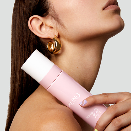 Model houdt Darling Screen-Me Spray SPF 30 tegen haar schouder