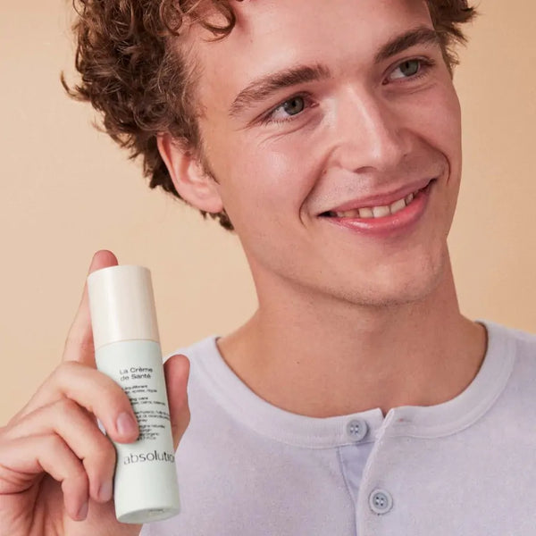 Jongen houdt La Crème de Santé van Absolution Cosmetics vast, een veelzijdige huidverzorging