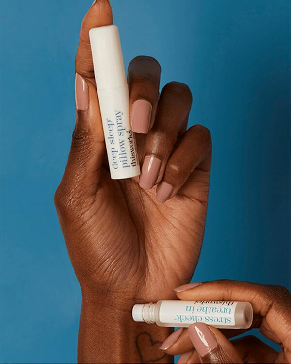 Handen houden de This Works Choose Sleep producten vast, voor een moment van diepe ontspanning en rus