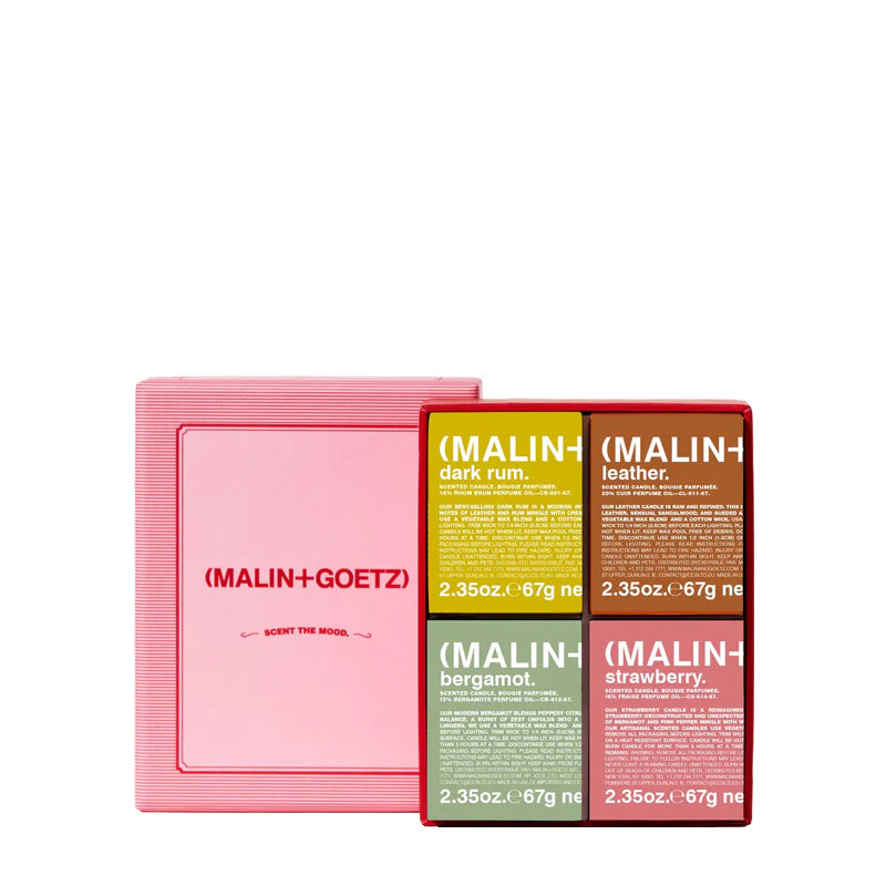 Open doos met vier luxe Malin+Goetz geurkaarsen  in erpakking