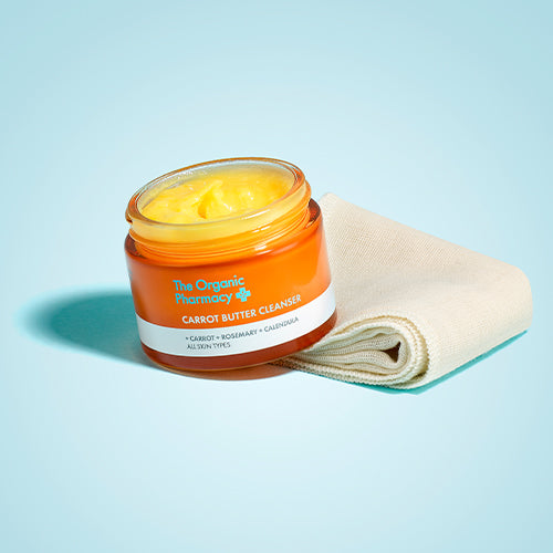 The Organic Pharmacy Carrot Butter Cleanser gepresenteerd op een mousseline doek, gereed voor gebruik